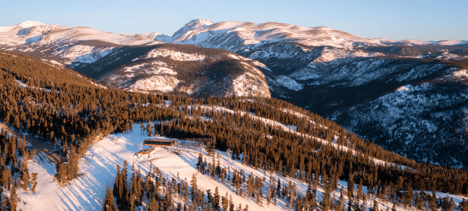 aerial photo of eldora mountain showing the slopes lit by early morning sun